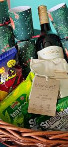 a basket of food and a bottle of wine at Waterfront Tropical Themed 2 BR in Abu Dhabi