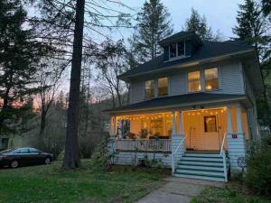 a house with lights on the front of it at Private Hot Tub - 3 bedroom Village Home in Fleischmanns
