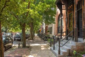 a sidewalk with trees and parked cars on a street at Top 1 Rated 4BR Lincoln Park House - King Bed in Chicago