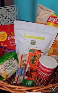 a basket filled with different types of snacks at Waterfront Tropical Themed 2 BR in Abu Dhabi