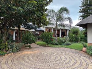 a circular brick driveway in front of a house at Ben & Bern House in Krugersdorp