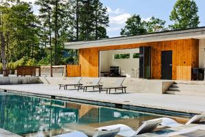 a house with a swimming pool in front of it at Wildcat Modern - 2br Firepit, Deck Dog Friendly in Young Harris