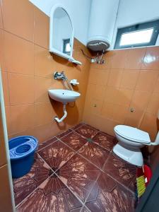 a bathroom with a toilet and a sink at Green Villa in Velipojë