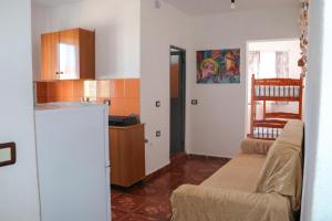 a living room with a couch and a kitchen at Green Villa in Velipojë +62 photos
