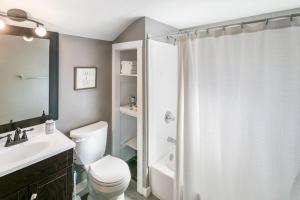 a bathroom with a white toilet and a shower at Home with Garage in DT Libertyville Near Naval Base in Libertyville +14 photos