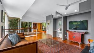 a living room with a couch and a tv at Mountain Breeze Retreat in Smithfield