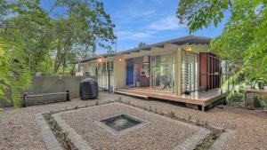 a house with a lot of glass in the yard at Mountain Breeze Retreat in Smithfield