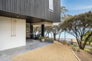 a house with a view of the ocean at Beachfront Studio with Breathtaking Views in Kingston Beach