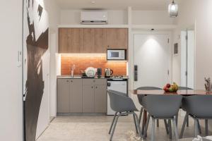 a kitchen and dining room with a table and chairs at Cactus 1 BR apartment in Gemmayze in Ar Rumayl
