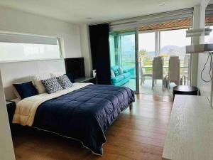 a bedroom with a large bed and a dining room at Country house near the airport and Medellin in El Retiro +93 photos