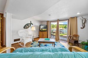 a living room with a couch and a table at PEACEFUL WATERS in Gravois Mills