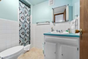 a bathroom with a white toilet and a sink at PEACEFUL WATERS in Gravois Mills +34 photos