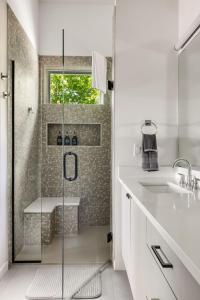 a white bathroom with a shower and a sink at Paradise View 4br Fall Retreat Firepit Dogs in Young Harris
