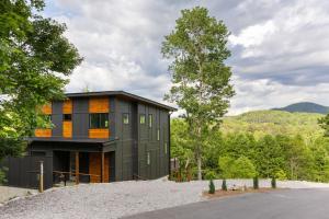 a house on top of a hill with trees at Skips Hideaway 4br Fall Retreat Hot Tub Dog in Young Harris