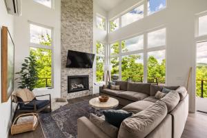 a living room with a couch and a fireplace at Skips Hideaway 4br Fall Retreat Hot Tub Dog in Young Harris