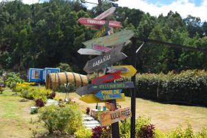 a street sign with many signs in a garden at Aldea Fuquenense in Fúquene