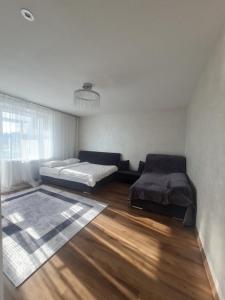 a room with two beds and a wooden floor at Апартаменти біля автостанції Кравчука, 40 in Lutsk