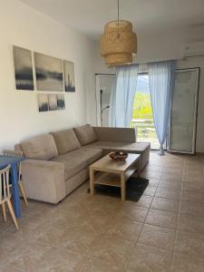 a living room with a couch and a table at Ariadni's home - With a sea view in Nea Stira