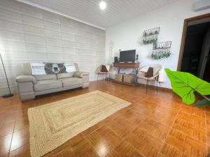 a living room with a couch and a table at House In The Valley in Algarvia