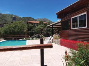 a house with a swimming pool next to a house at Cabañas Buena Vista in Los Cocos