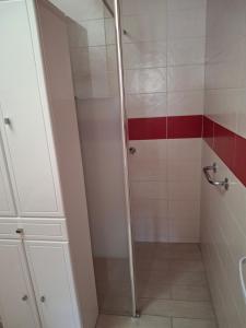 a shower with a glass door in a bathroom at Ker Ode in La Plaine-sur-Mer