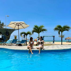 two women in the swimming pool at a resort at Nauti-k Beach Hotel in Tumbes +35 photos