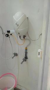 a bathroom with a water hose hooked up to a sink at Mamalakandam - Egg House - in Diya Homestay in Mamalakandam
