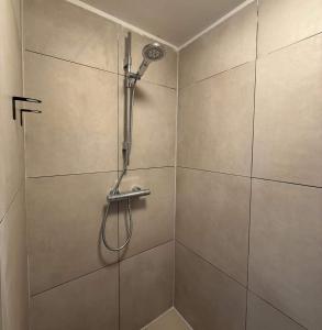 a shower stall with a shower head on a wall at Cozy Private Room 6 with Balcony in Eindhoven +3 photos