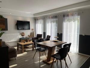 a living room with a wooden table and chairs at Apartment Nikki in Medebach