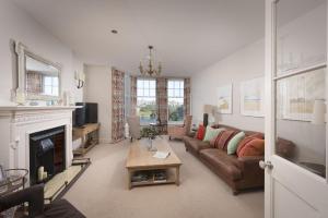 a living room with a couch and a fireplace at Dolly's Plaice, Fowey in Fowey