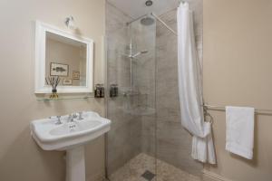 a bathroom with a sink and a shower at Dolly's Plaice, Fowey in Fowey +29 photos