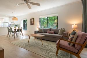 a living room with a couch and a table at Private Tropical Beach Oasis - Aloe in Cape Canaveral