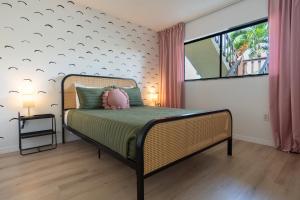 a bedroom with a bed and a large window at Private Tropical Beach Oasis - Aloe in Cape Canaveral