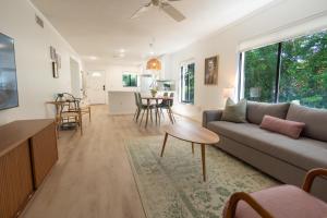 a living room with a couch and a table at Private Tropical Beach Oasis - Aloe in Cape Canaveral