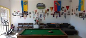 a living room with a pool table and flags at Domki u Christiana in Nadole