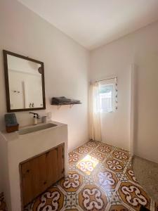 a bathroom with a sink and a mirror at Casa Leone La Punta in Brisas de Zicatela