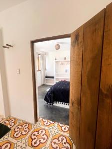 a mirror in a room with a bed in it at Casa Leone La Punta in Brisas de Zicatela +19 photos