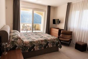 a bedroom with a bed and a chair and a window at Villa Incanto in Mezzegra +94 photos