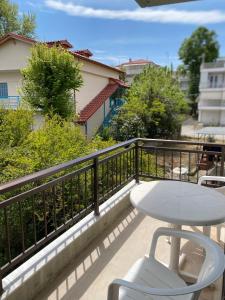 a white table and a chair on a balcony at Maira House in Platamonas