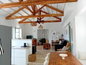 a living room with white walls and wooden beams at Villa Aquilo in Megali Ammos