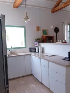 a kitchen with white cabinets and a counter top at Villa Aquilo in Megali Ammos