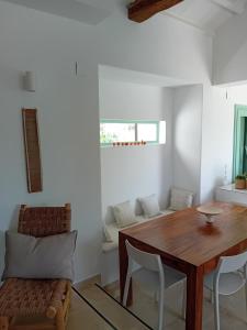 a dining room with a wooden table and chairs at Villa Aquilo in Megali Ammos
