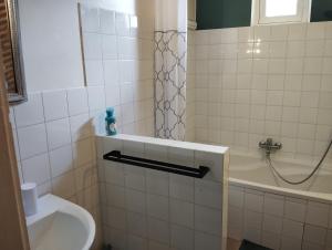 a bathroom with a sink and a toilet and a tub at La Coquerie in Fondettes +3 photos