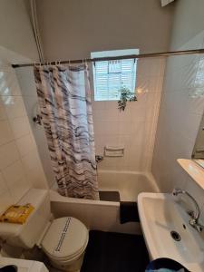 a bathroom with a tub and a toilet and a sink at Ellie's house in Kozani +29 photos