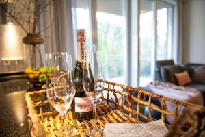 a bottle of wine and two glasses on a table at Oldenburg 03 in Wangerooge