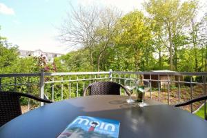 a table with a magazine and a glass of wine at Oldenburg 03 in Wangerooge