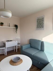 a living room with a blue couch and a table at Ostseeliebe 5 in Dahme