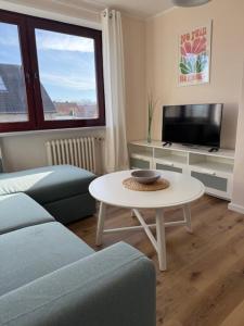 a living room with a couch and a table at Ostseeliebe 5 in Dahme