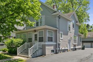 a gray house with white trim at Spacious Home in DT Libertyville Near Naval Base in Libertyville