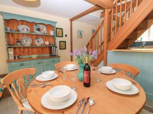 a dining room table with a bottle of wine on it at 45 Georges Square in Lyme Regis
